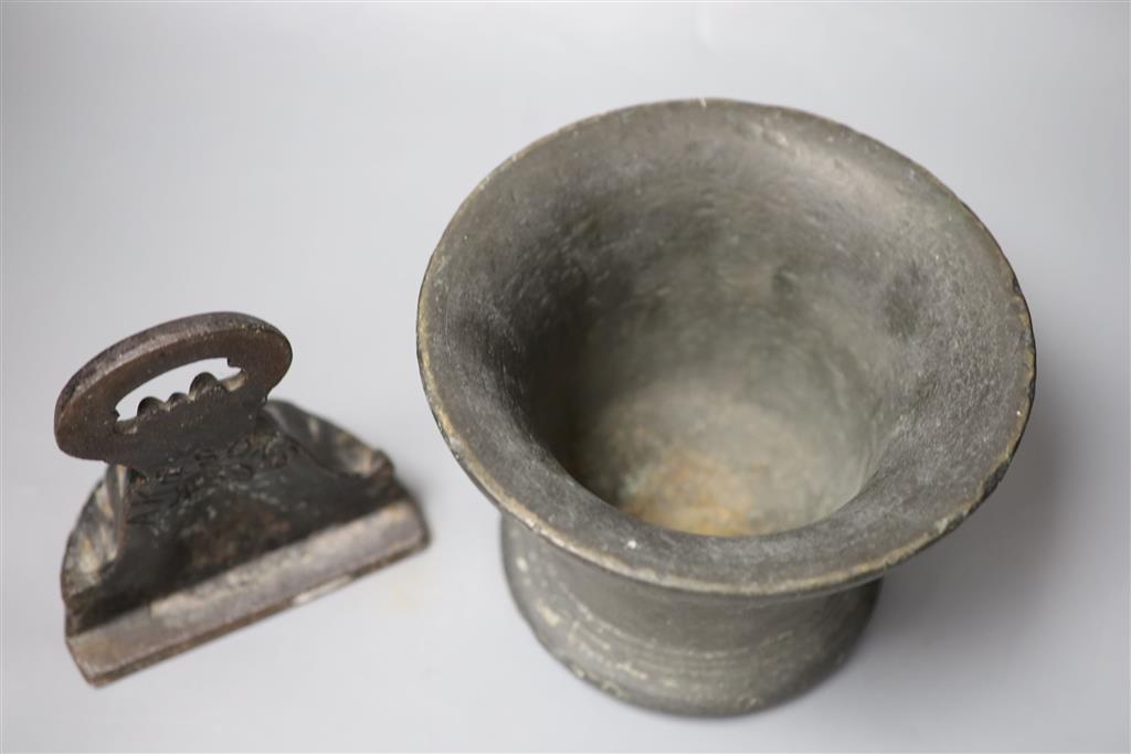 A 16th/17th century bronze mortar, height 16cm, and a cast iron doorstop